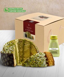 Bronte store pistachio panettone with squeezer jar of pistachio cream, on a wooden table with white boards, in a room with a coffee-coloured wall.
