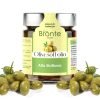 Jar of olives in oil with silver cap and yellow and green label. Several green olives framing.