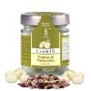 jar of Bronte store brand pistachio pralines. Pistachio confetti in glass with silver cap and green and beige labels
