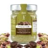 Jar of Bronte store-brand PGI pistachio cream and chocolate from Modica. Silver-coloured cap, green and brown label, and shelled pistachios and chocolate as a frame.