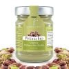 Jar of Bronte store-brand Sicilian pistachio cream 'Pistacia Top'. Several shelled pistachios framing